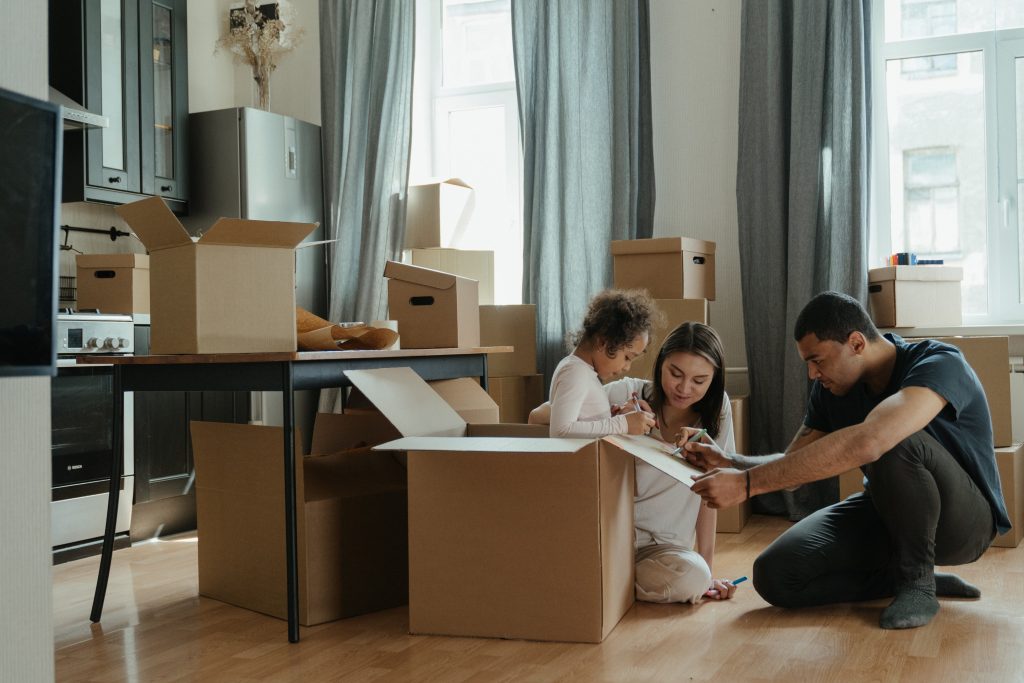 family packing moving boxes at home